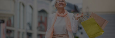 elderly lady in adult diapers walking down street with bags