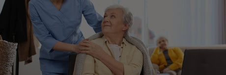 elderly mom and daughter touching hands