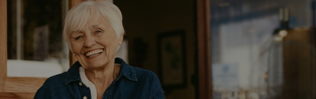 old person in cafe smiling 