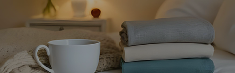 warm and cozy bed with mug and blankets